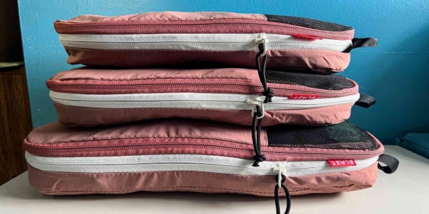 A stack of pink and black bags AI-generated content may be incorrect.